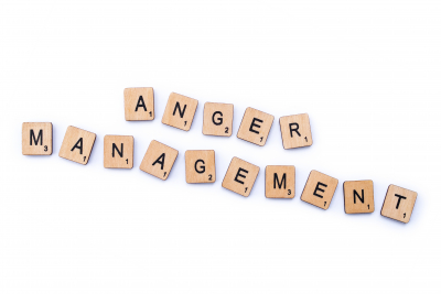The phrase ANGER MANAGEMENT, spelt with wooden letter tiles